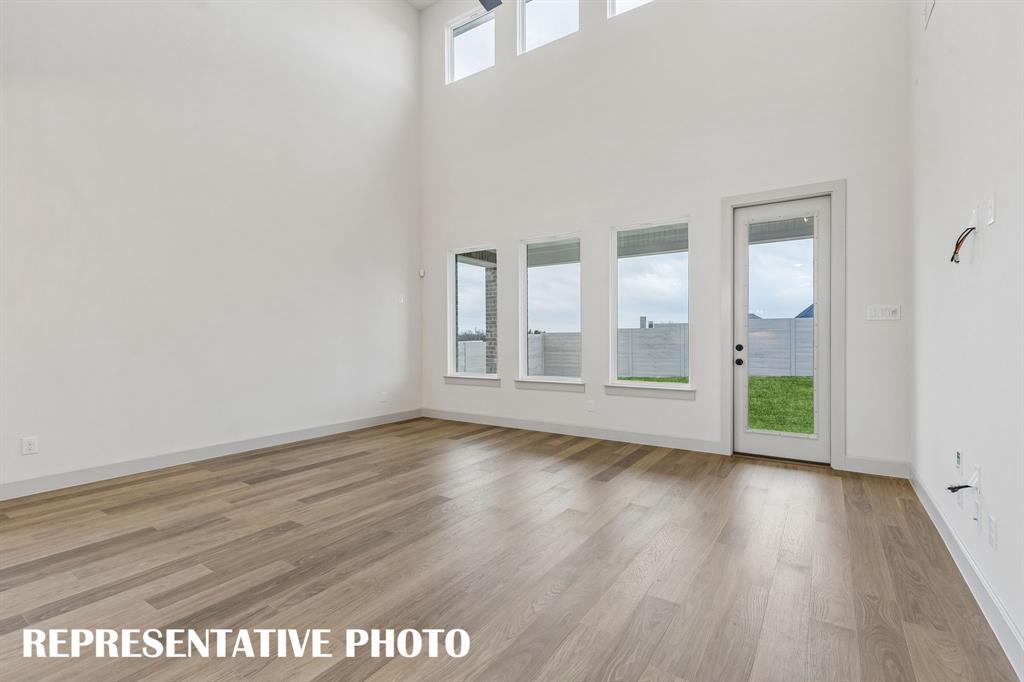 Dual story windows flood this family room with natural light!  REPRESENTATIVE PHOTO