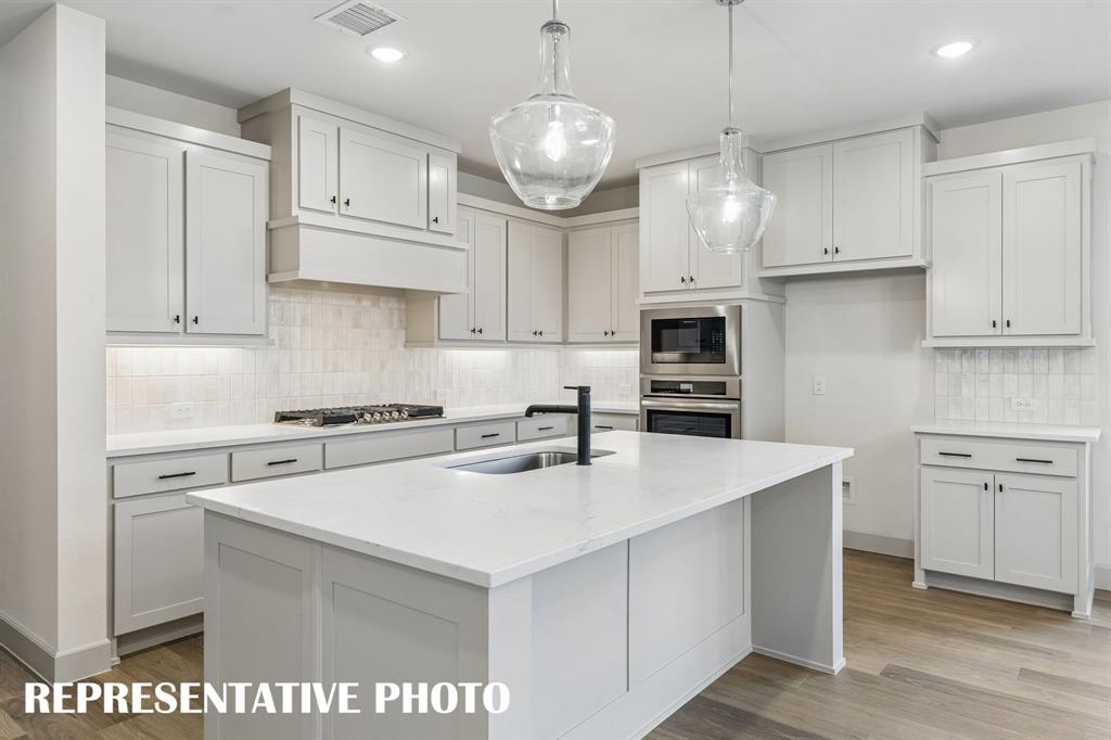 Featuring outstanding storage and prep space, the chef in the family will fall in love with this dream kitchen!  REPRESENTATIVE PHOTO