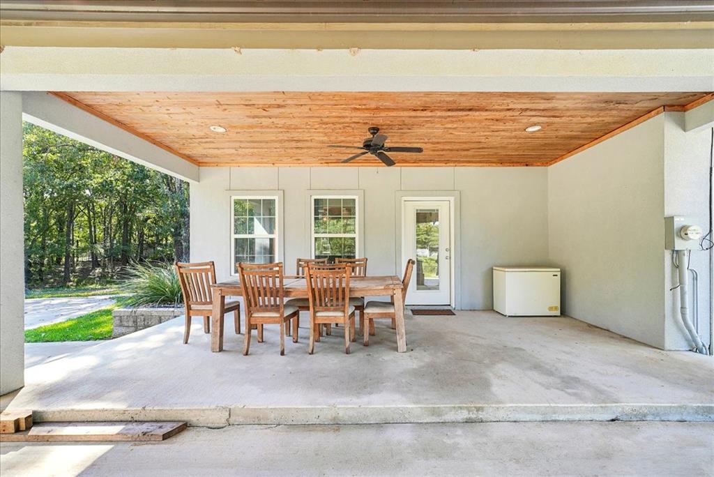 Covered patio featuring a wood-plank ceiling, ceiling fan, recessed lighting, and concrete flooring
