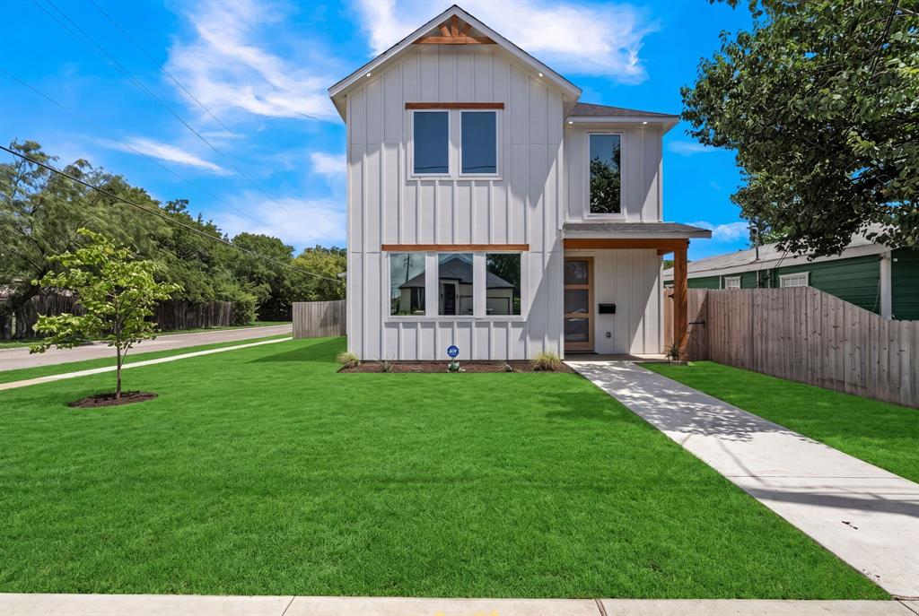 Modern board-and-batten exterior with timber accents, covered entry, and concrete walkway