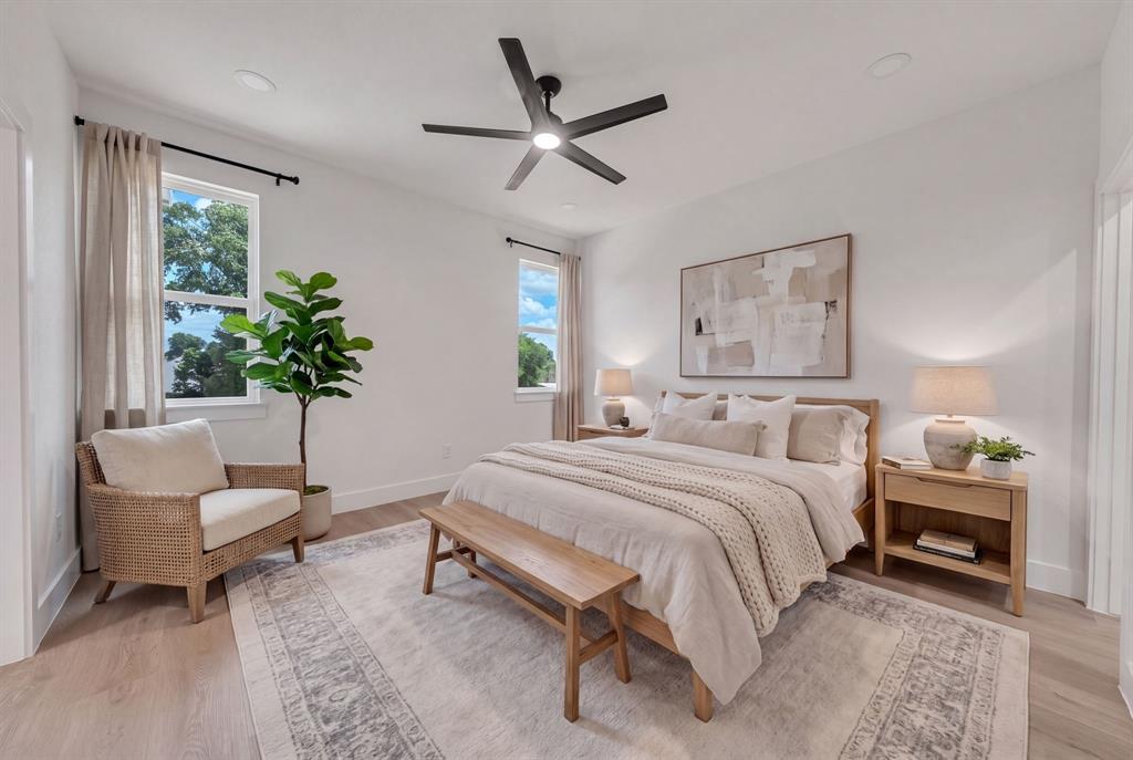 Room featuring wood-finish flooring, recessed lighting, matte black ceiling fan, and dual pane windows