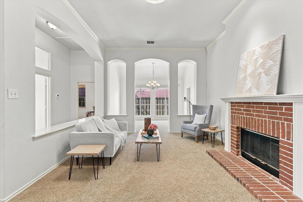 Living area featuring high ceilings, pass through fireplace, and dining room.