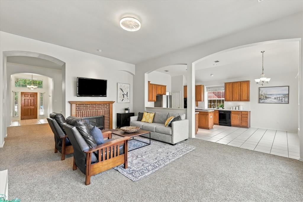 Den shares pass through gas log fireplace with formal living.