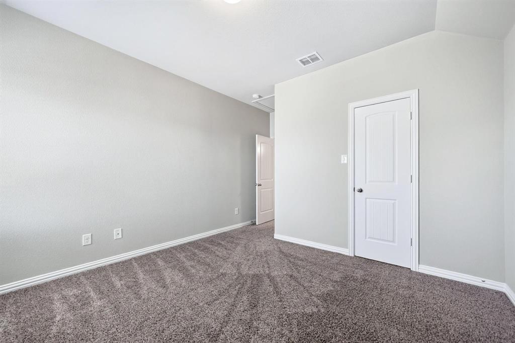 Neutral wall palette featuring textured finishes, wall-to-wall carpeting, and white interior paneled doors