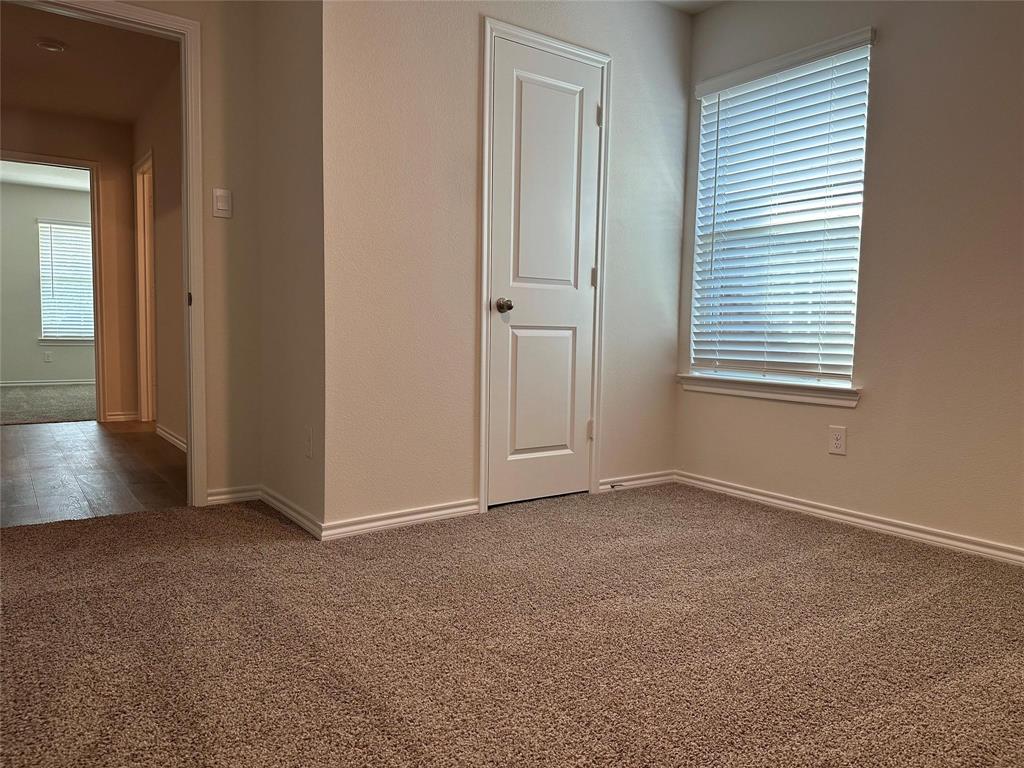 Unfurnished room with carpet flooring and baseboards