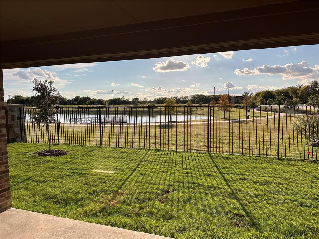 View of yard with a water view and a patio