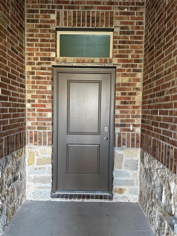 Property entrance with brick siding