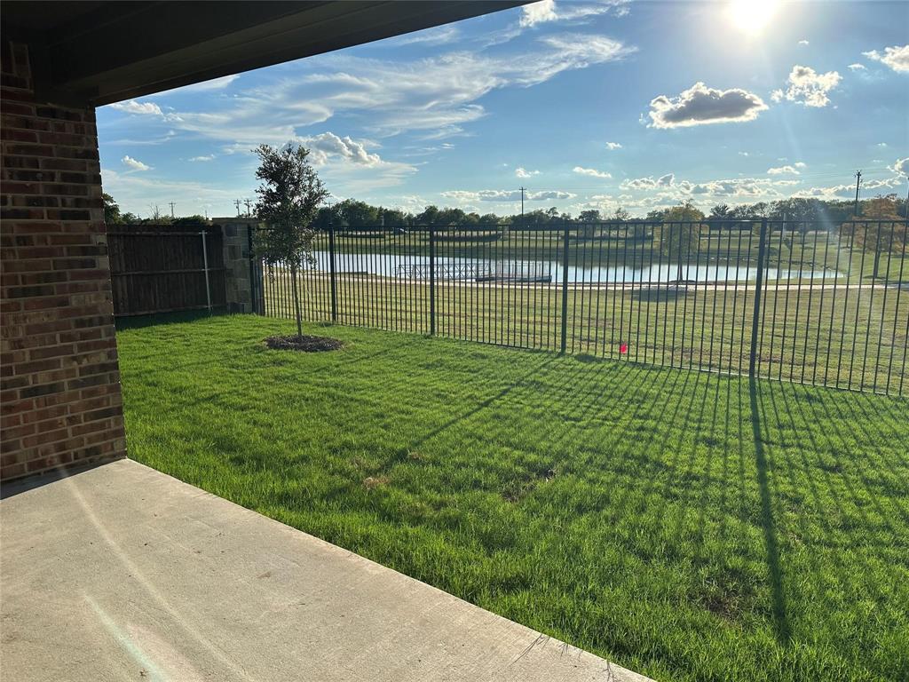 View of yard with a water view and a patio area