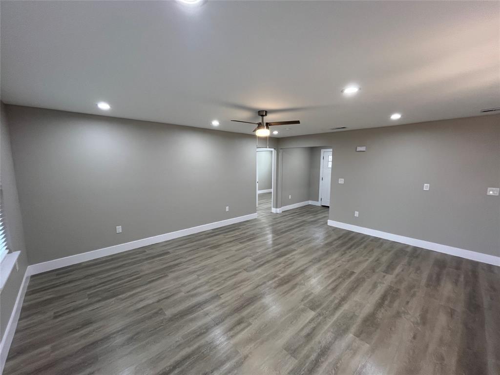 Interior space featuring wood-finish flooring, recessed lighting, and a central ceiling fan Interior space featuring wood-finish flooring, recessed lighting, and a central ceiling fan
