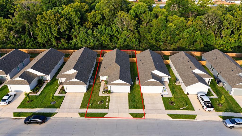 Single-story residence featuring an asphalt shingle roof, attached garage, concrete driveway, and front lawn