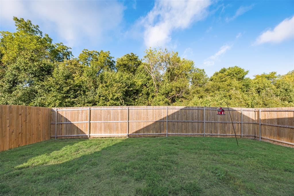 Backyard featuring a grass lawn and wood privacy fencing