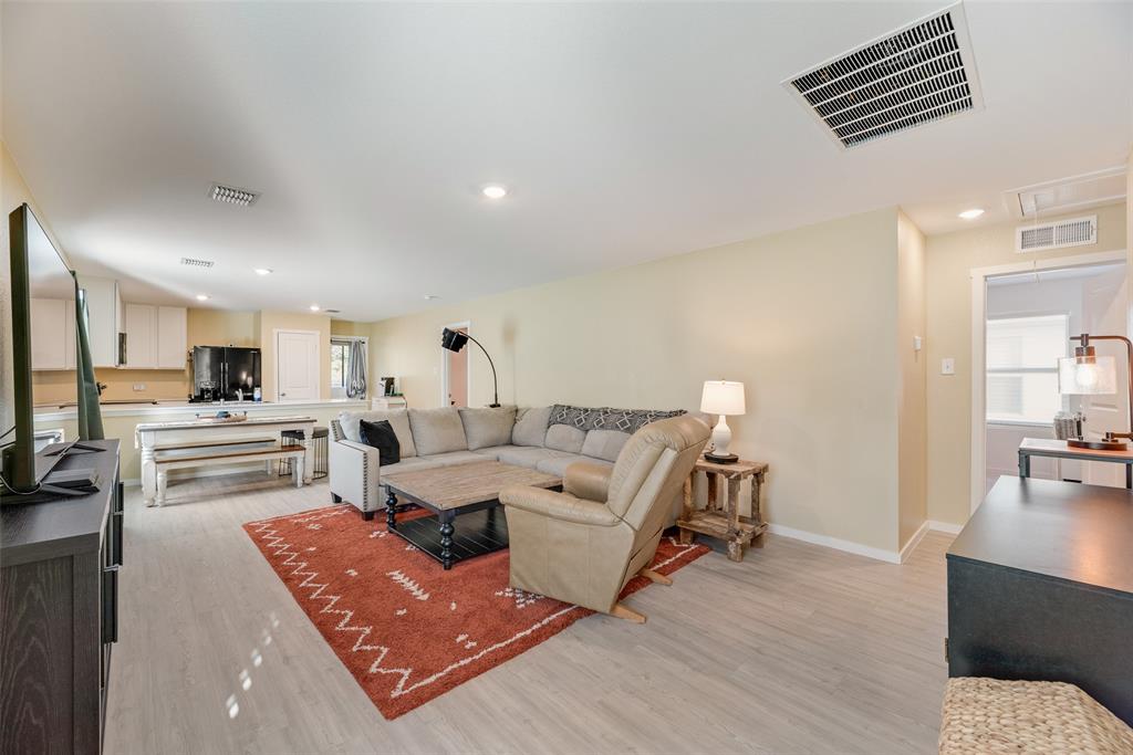 Open-concept interior featuring wood-finish flooring and recessed lighting throughout