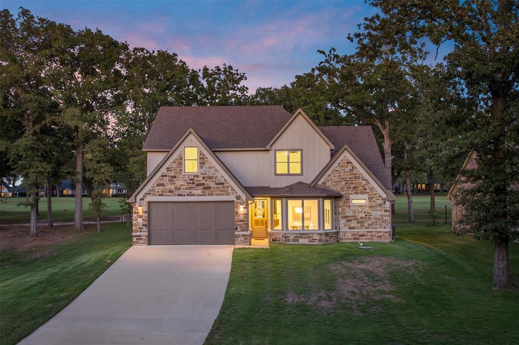 Classic farmhouse facade perched on a gentle hill