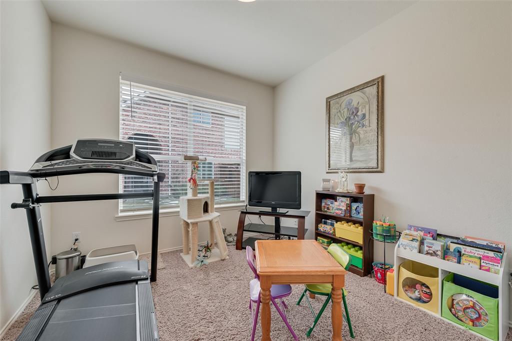 Room featuring neutral wall tones, wall-to-wall carpeting, and a window with installed horizontal blinds