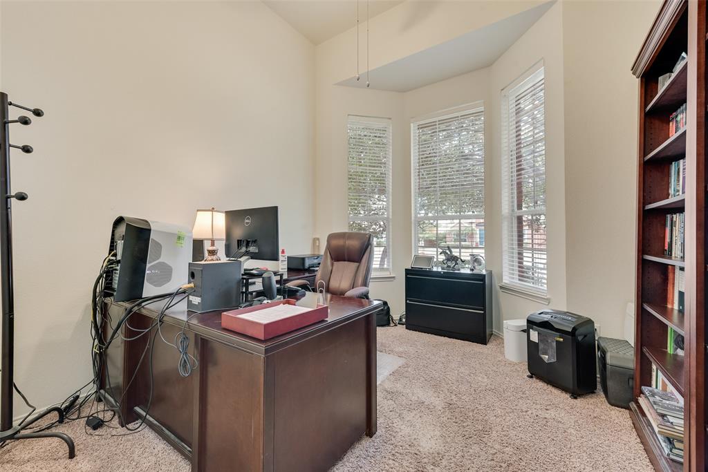 Vaulted ceilings, bay window configuration, and carpeted flooring