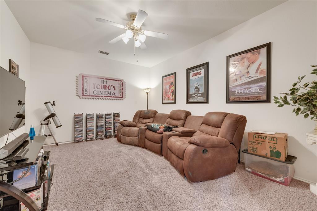 Enclosed room featuring carpeting and a central ceiling fan with multi-light fixture