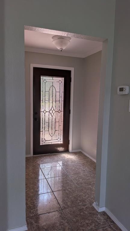 Entryway featuring a dark-finish door with decorative glass inlay, tiled flooring, and a flush-mount ceiling light