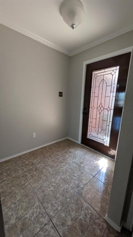 Entryway featuring large-format ceramic tile flooring, a dark-finish door with decorative glass inlay, and a flush-mount ceiling light fixture