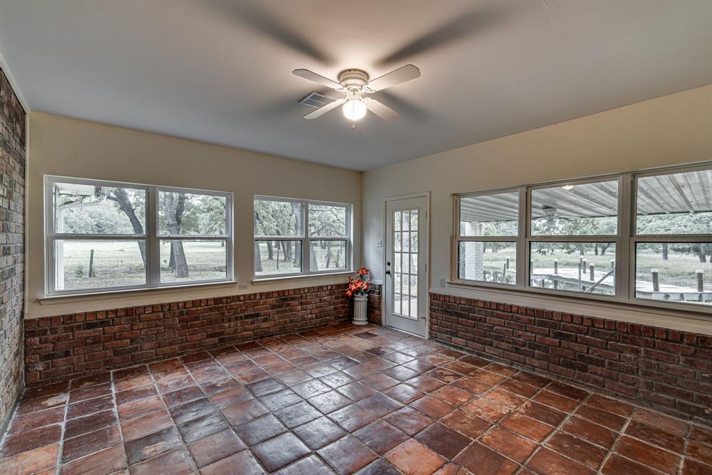 Enclosed & air conditioned sun room with view of dock & pond