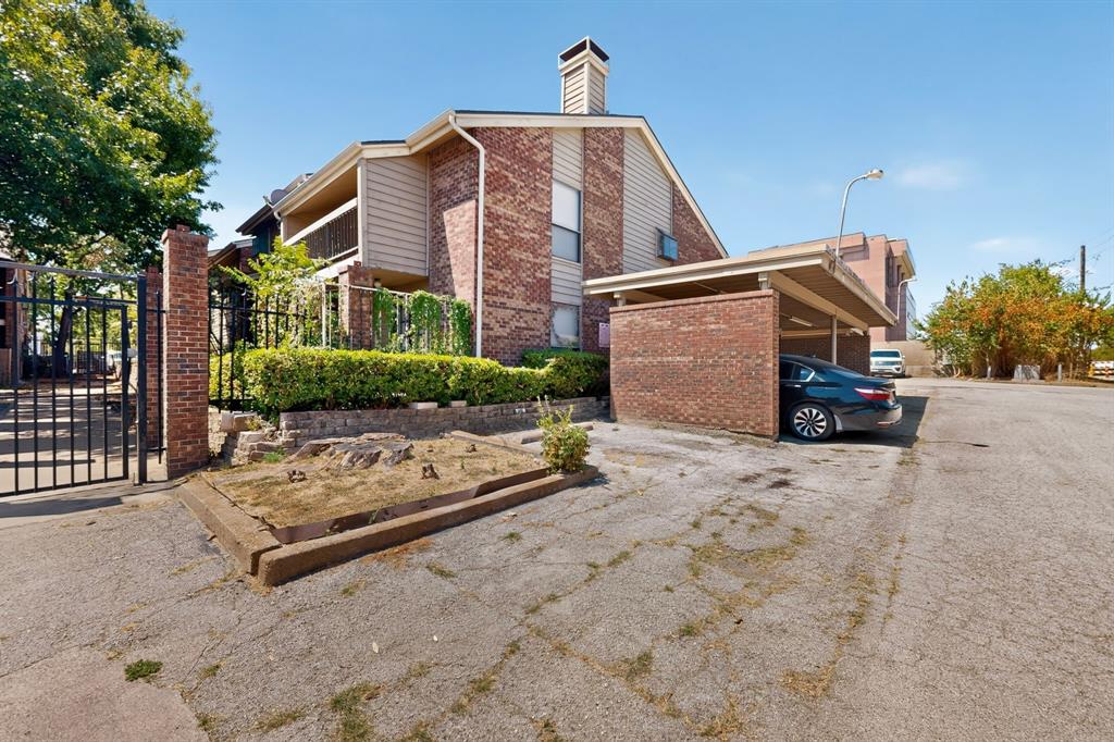 Brick exterior with siding accents, a prominent brick chimney, and an integrated carport structure