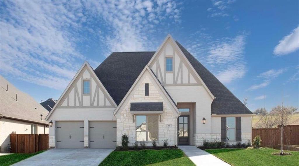 Tudor-inspired exterior featuring stone masonry, half-timbered gables, a steep roofline, multi-pane windows, and a two-car garage Tudor-inspired exterior featuring stone masonry, half-timbered gables, a steep roofline, multi-pane windows, and a two-car garage