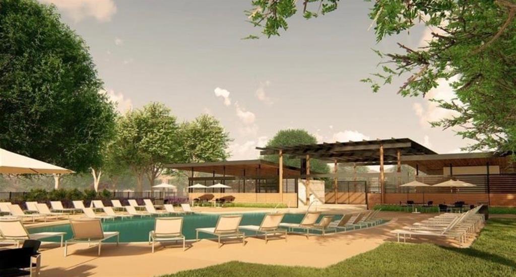 Outdoor recreation area featuring an in-ground swimming pool, concrete decking, and a large permanent pavilion with integrated overhead structure