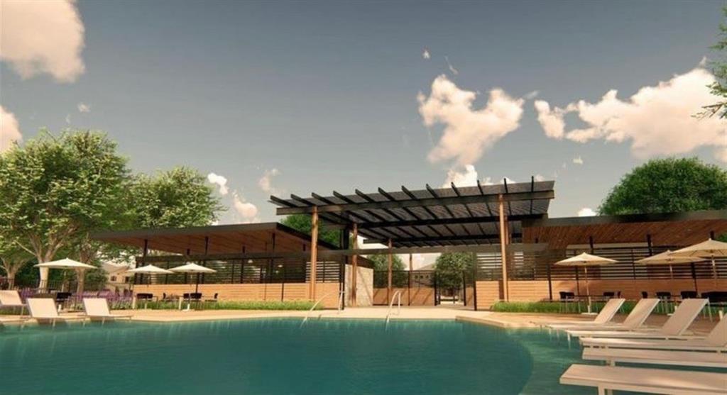 Swimming pool featuring a poolside deck, expansive overhead trellis, brick-accented structure, and mature landscaping