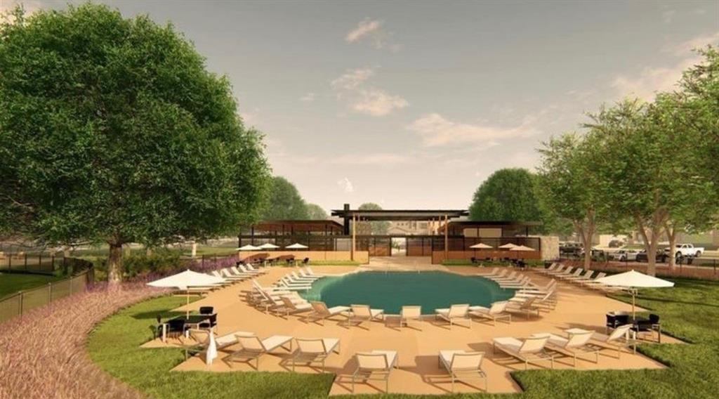 Swimming pool featuring a concrete deck and a covered pavilion with metal roof detailing
