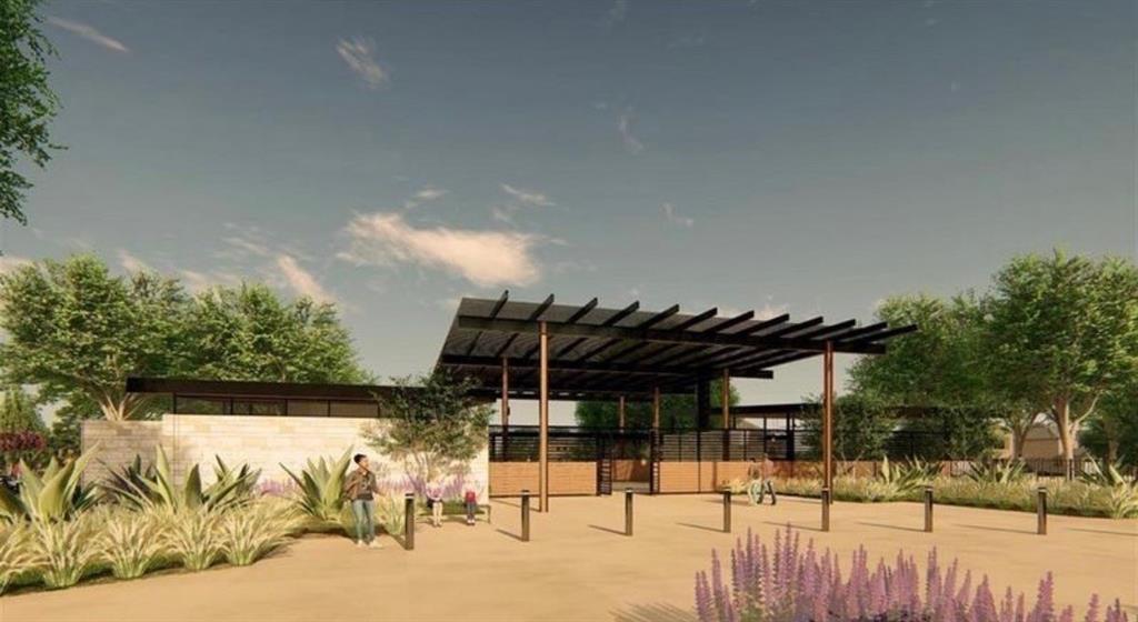 Modern architectural exterior featuring a stone-clad facade, extensive metal pergola structure, and xeriscaped landscaping