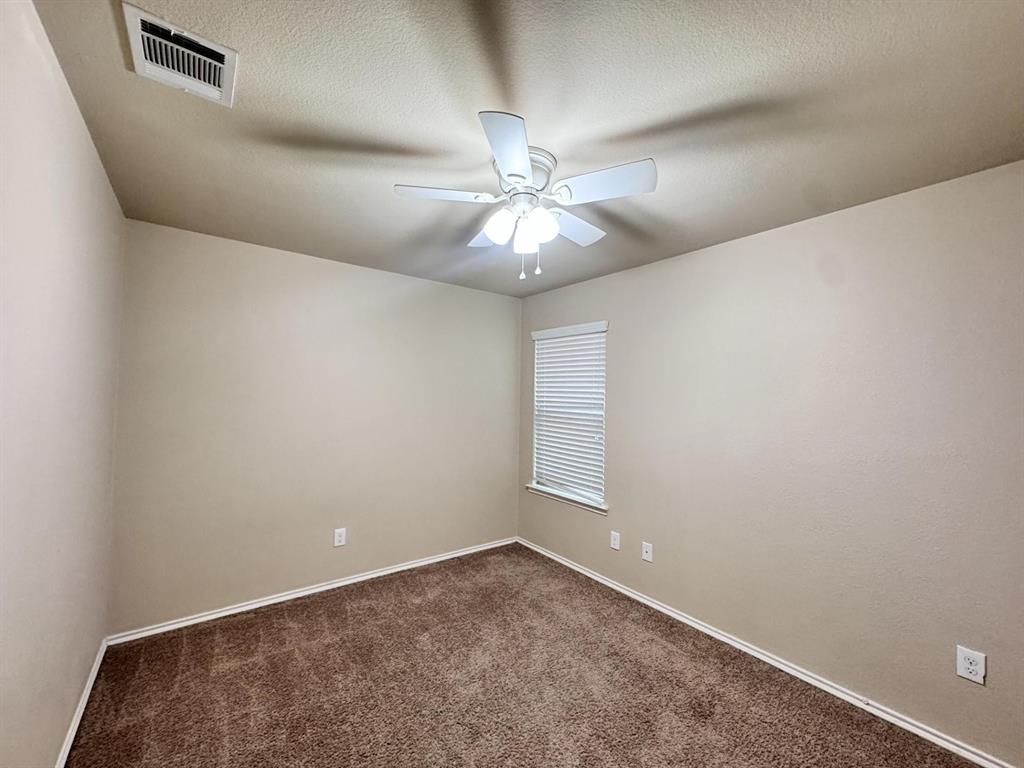 Room featuring neutral wall tones, plush carpeting, a multi-blade ceiling fan with an integrated light fixture, and horizontal window blinds