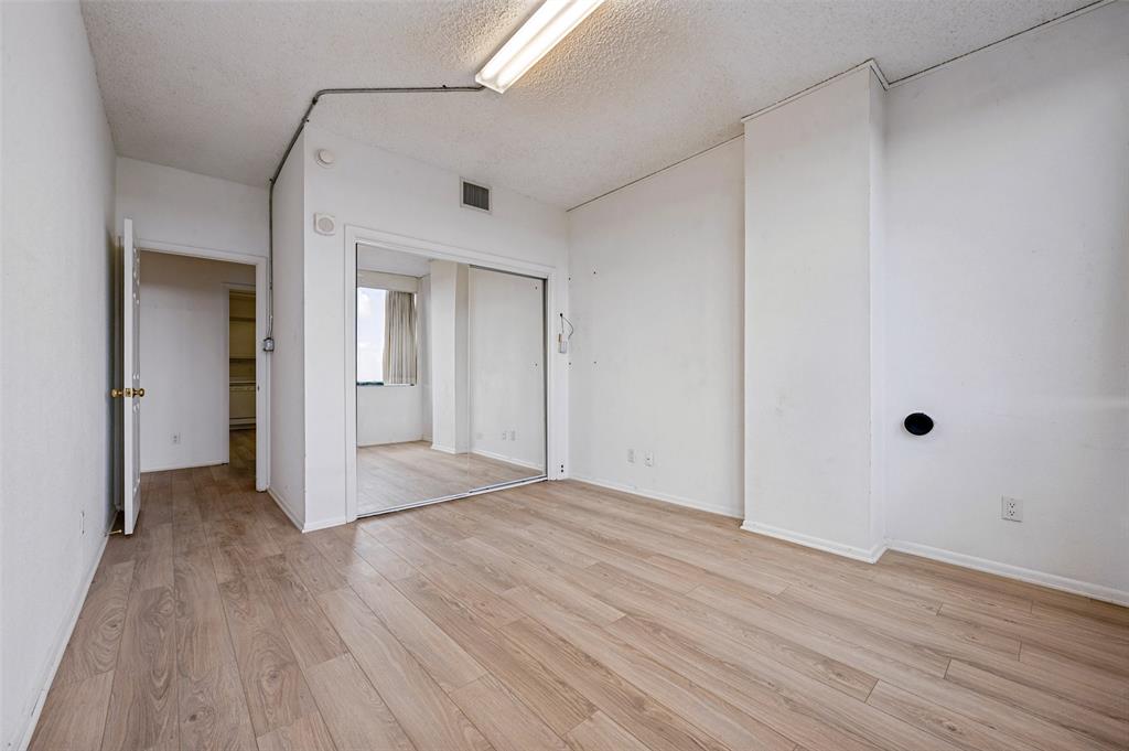 Wood-finish flooring, sliding mirror-panel closet doors, and interior doorway access