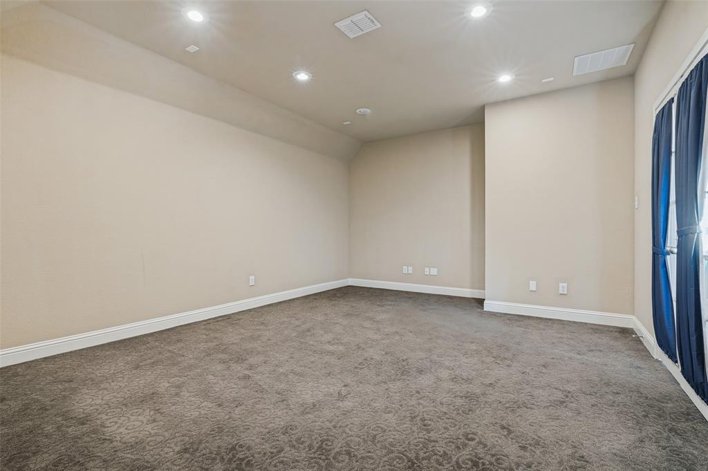 Neutral-toned room featuring recessed ceiling lighting, wall-to-wall carpeting, and a glass-paneled door