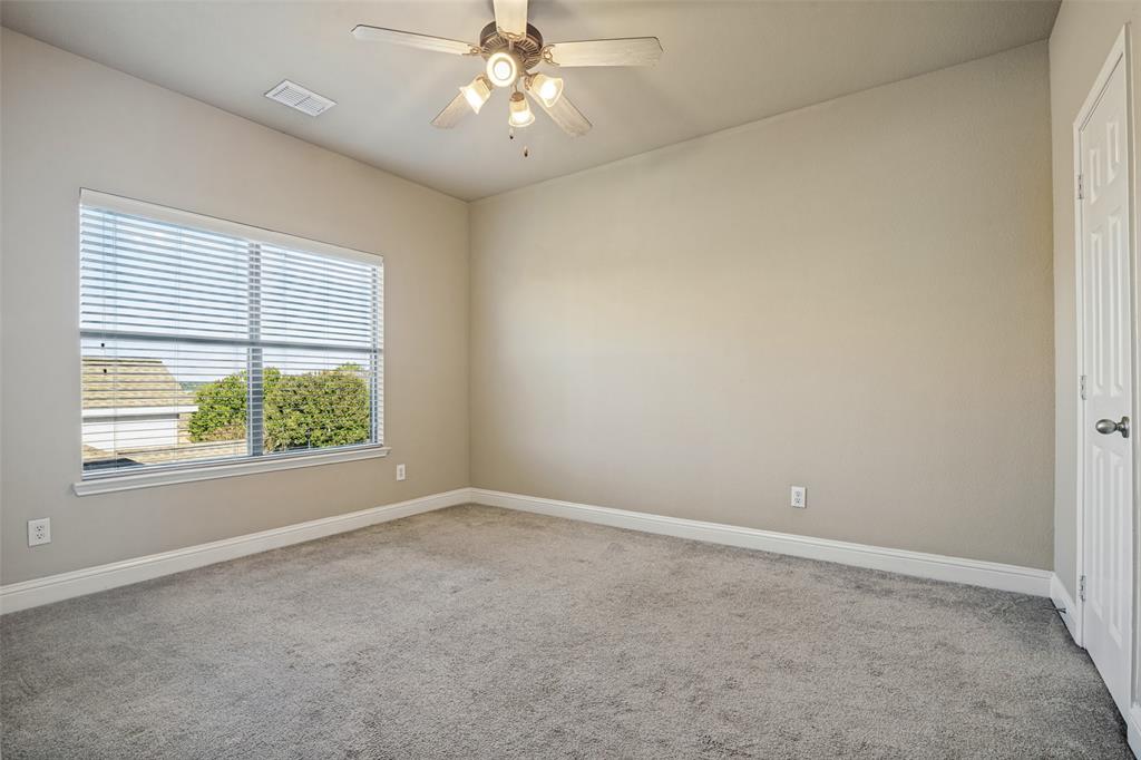 Room featuring neutral wall tones, plush wall-to-wall carpeting, a multi-blade ceiling fan with integrated lighting, and a window with horizontal blinds