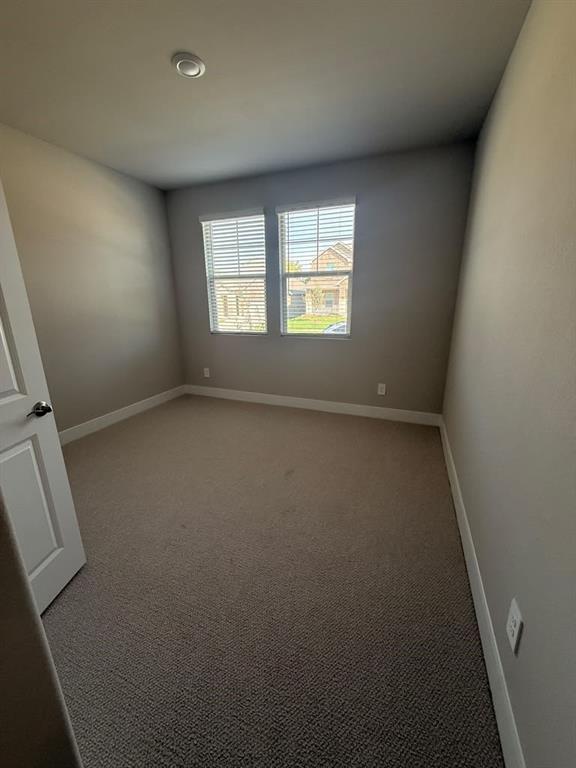 Room featuring neutral wall tones, wall-to-wall carpeting, dual windows with integrated blinds, and a recessed ceiling light