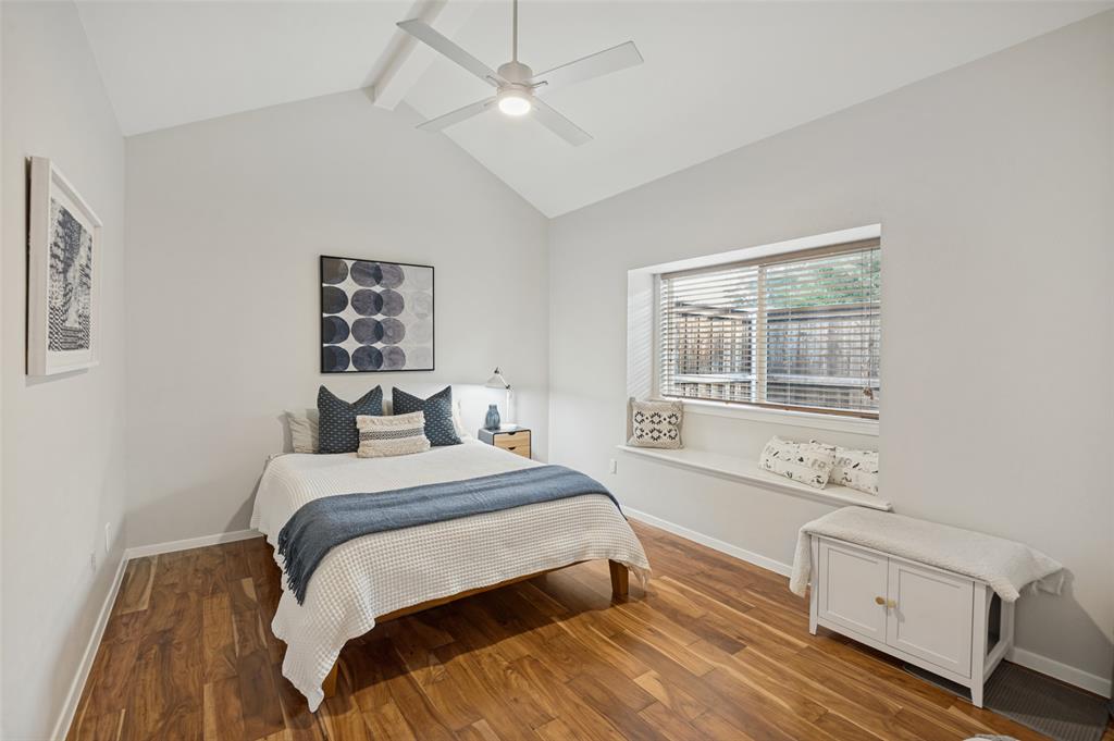 Bedroom with window seat and vaulted ceilings