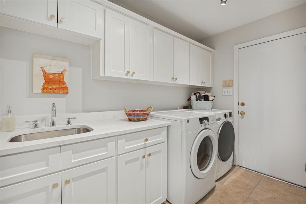 Laundry room with quartz counters, sink, and updated cabinets