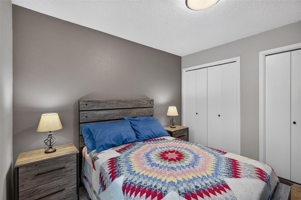 Neutral wall tones, ceiling-mounted lighting, and dual white bi-fold closet doors