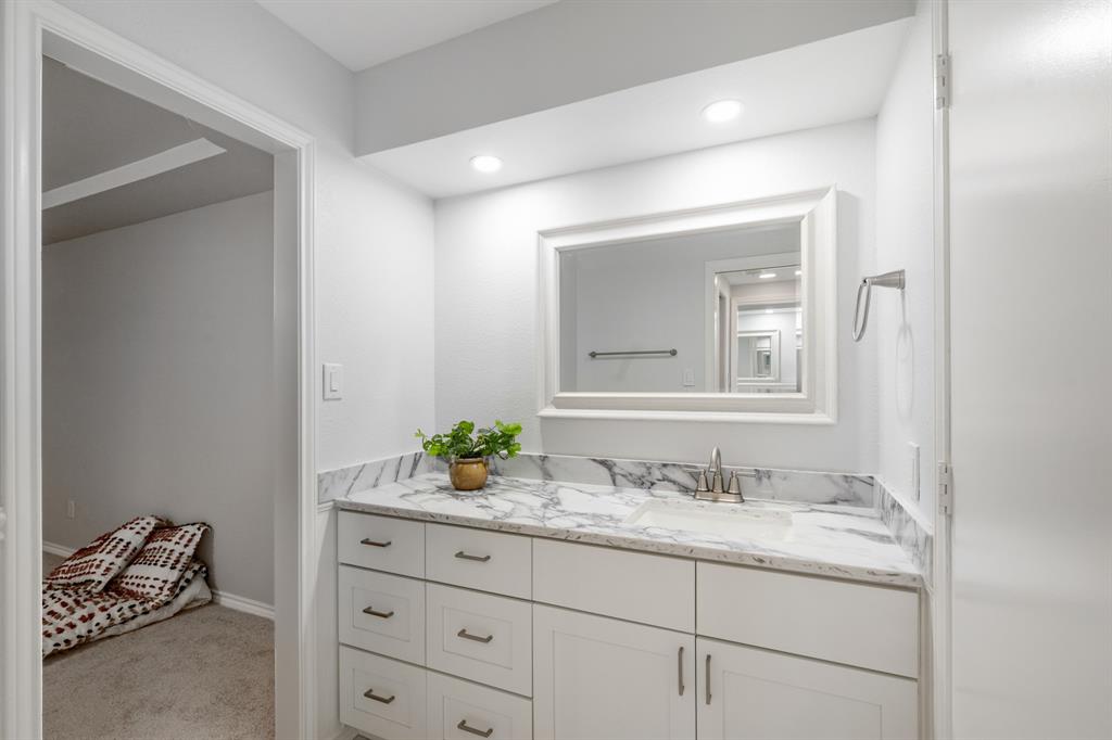 Built in storage in primary bathroom with a walk in closet.