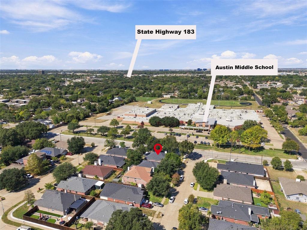 Aerial perspective of residential neighborhood featuring mature trees and street-level infrastructure