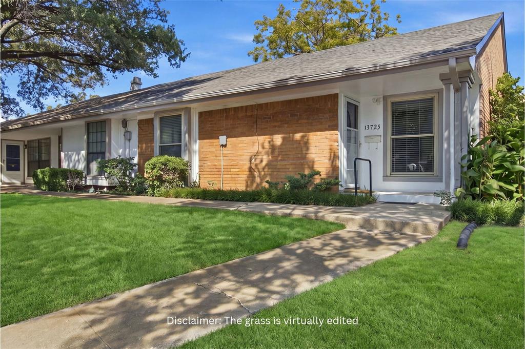 Single-story residence featuring a brick and painted exterior, gabled roofline, covered entryway, and mature landscaping