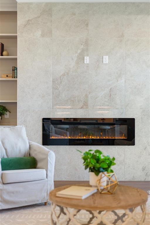 Floor to ceiling tile highlights electric fireplace Floor to ceiling tile highlights electric fireplace