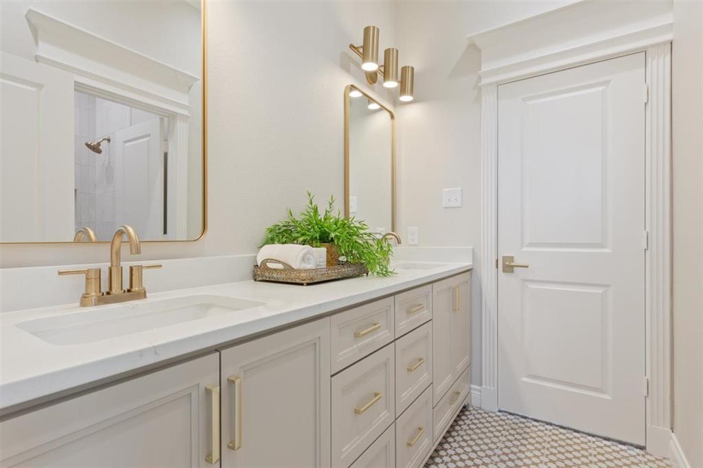 Jack and Jill bath connects front and back bedrooms, dual vanities