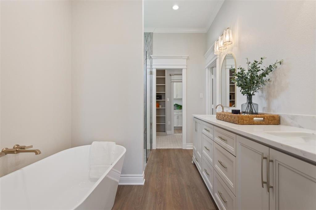 Site lines through bathroom through primary closet into laundry room