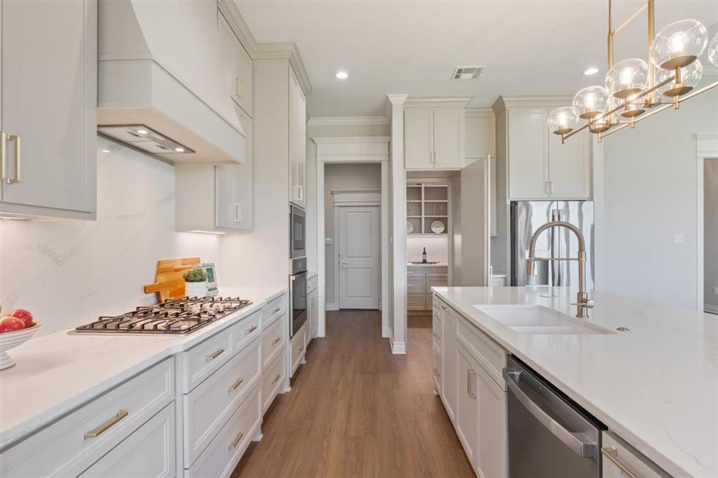 Hidden pantry door open to 140 square foot pantry with built ins