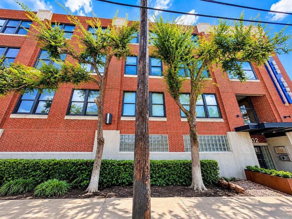 Red brick exterior featuring multi-pane windows, concrete masonry accents, and decorative glass block detailing Red brick exterior featuring multi-pane windows, concrete masonry accents, and decorative glass block detailing