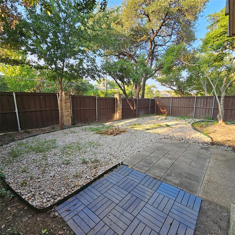 Fenced backyard with a patio
