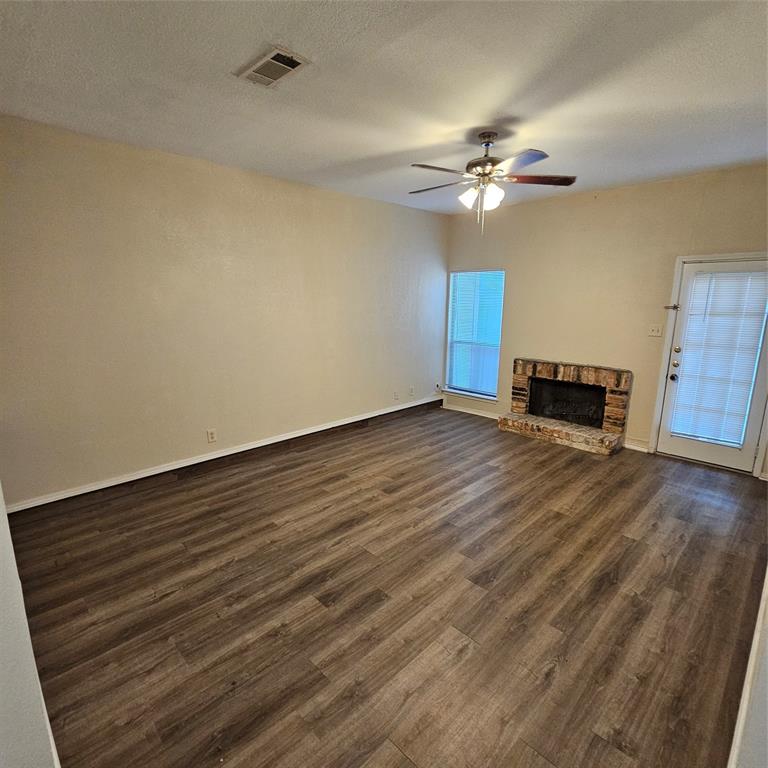 Living room with fan and fireplace
