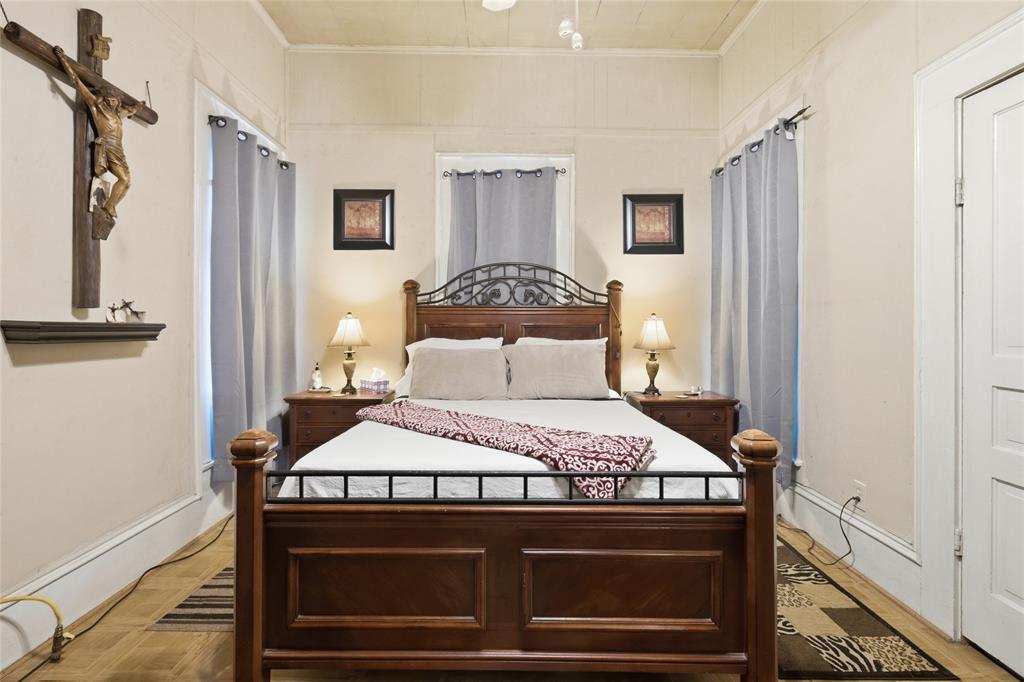 Room featuring wood-finish flooring, paneled walls, a neutral ceiling, and white door trim
