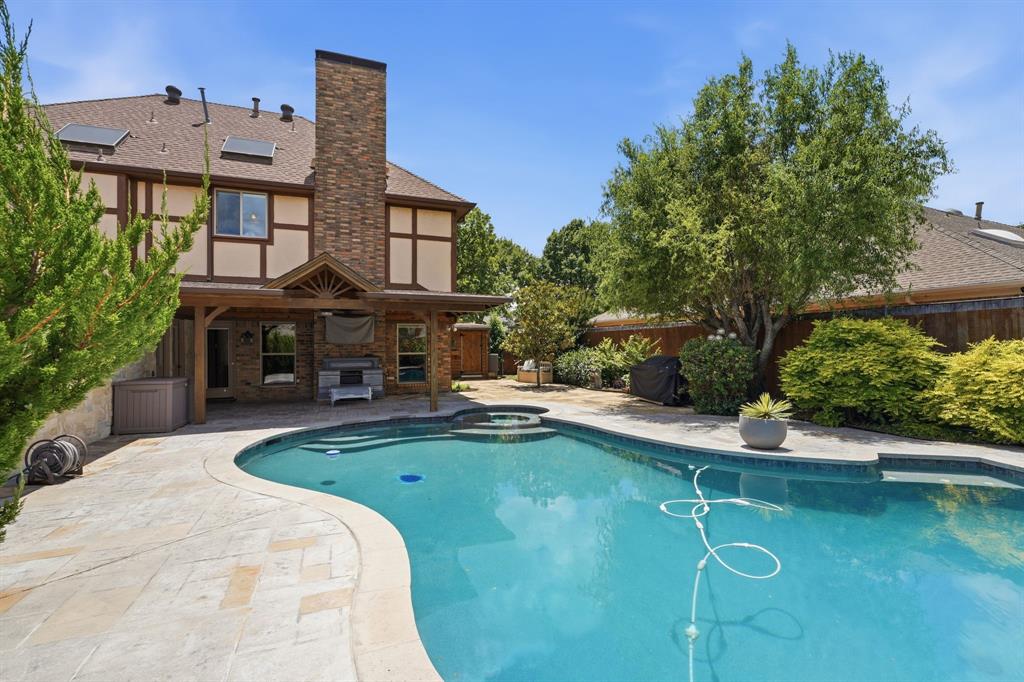 View from back of pool to the home.  Take a look at that oversized covered patio, great for gathering outside in the Fall.