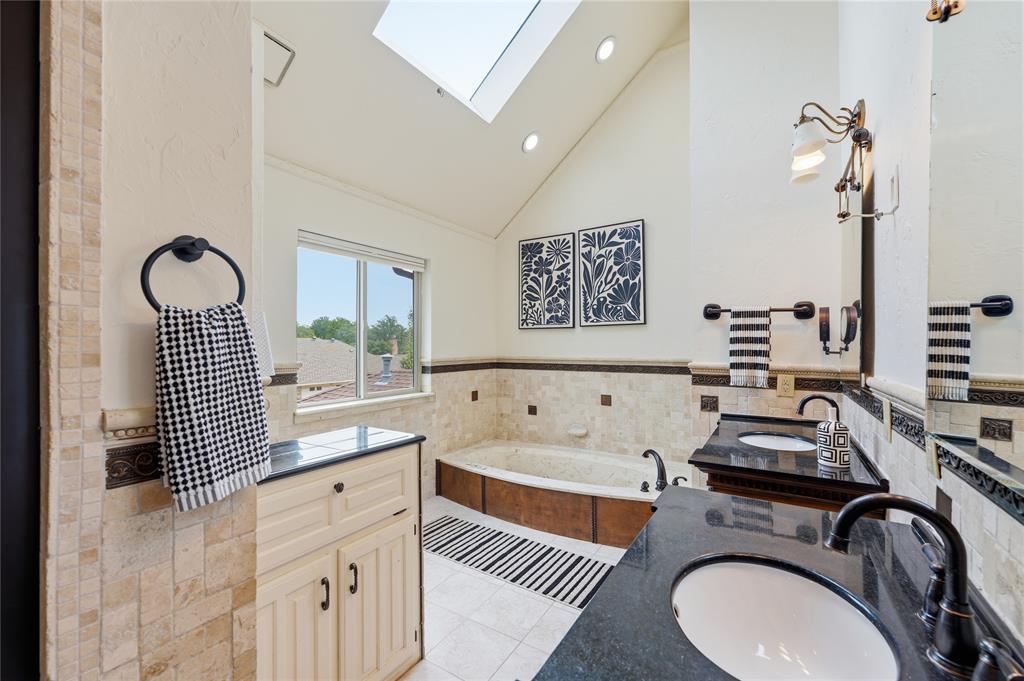 Enjoy the vaulted ceilings inside this primary bathroom.